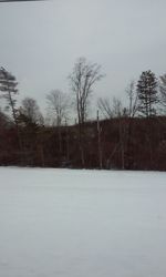 Snow covered field against sky