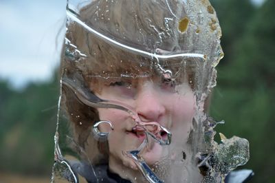 Close up of boy seen through frozen glass