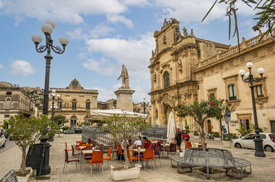 The beautiful busacca square in scicli with monument and church