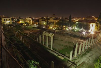 High angle view of illuminated buildings against sky at night