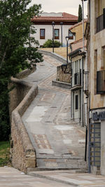 Footpath amidst buildings in city