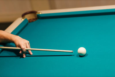 Cropped hand playing pool