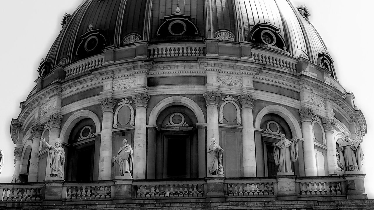 architecture, building exterior, built structure, low angle view, window, facade, arch, history, city, outdoors, building, no people, day, sky, church, old, text, travel destinations, ornate, religion