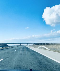 Bridge over road against blue sky