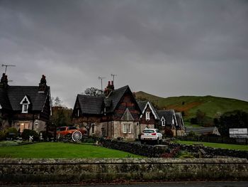 Houses and buildings against cloudy sky