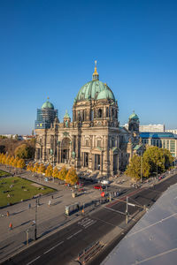 Buildings in city against blue sky