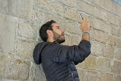 Person standing against wall