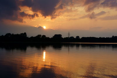 Scenic view of lake against orange sky