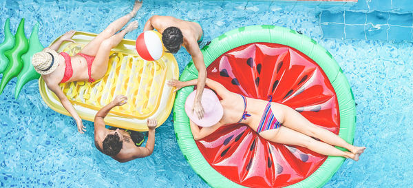 Directly above shot of friends enjoying swimming pool