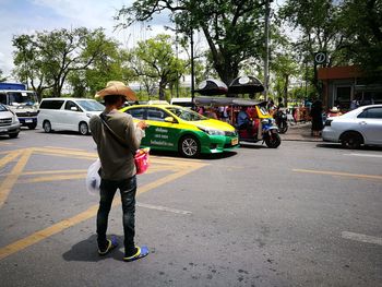 Full length of man standing on street in city