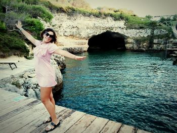 Full length of woman standing in water