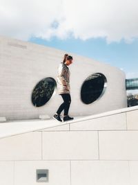 Full length of woman standing against sky