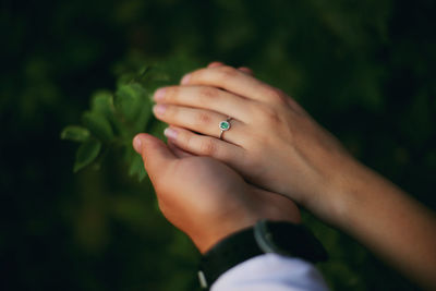 Close-up of woman hand on leaf