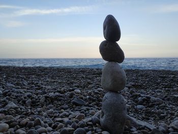 Rocks on beach against sky