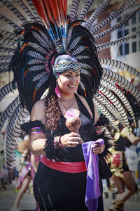 Full length of happy woman holding umbrella