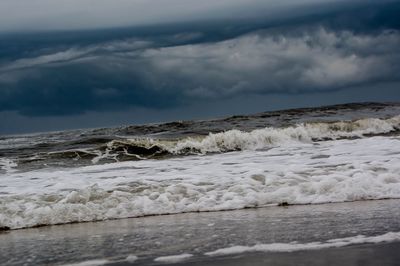 Scenic view of sea against storm clouds