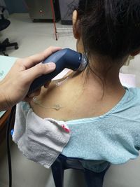 Cropped hand of woman giving shoulder massage to customer in spa