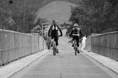 People riding bicycle on road