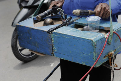 Midsection of man holding equipment