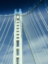 Low angle view of suspension bridge against sky