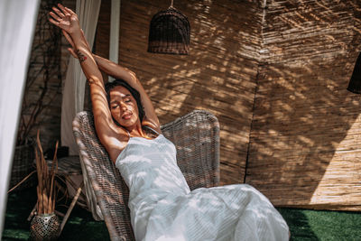 Portrait of young woman sitting on hammock