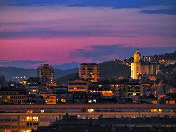 High angle view of illuminated buildings against sky at sunset