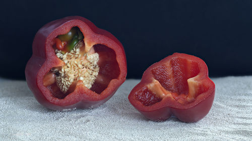 Close-up of strawberry on table against black background