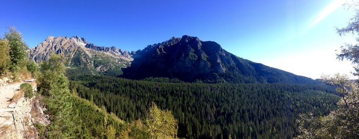 Scenic view of mountains against blue sky