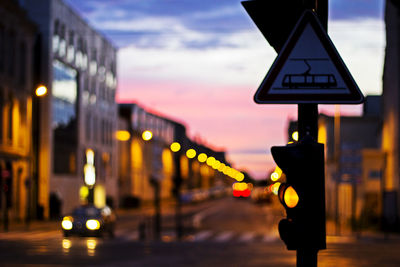 Close-up of road sign at night