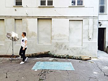Full length of woman standing in front of building