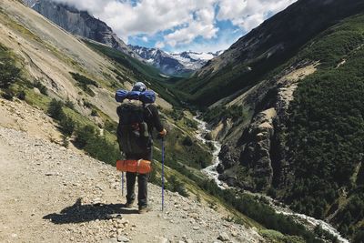 Rear view of woman standing on mountain road