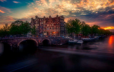 Bridge over river against sky during sunset