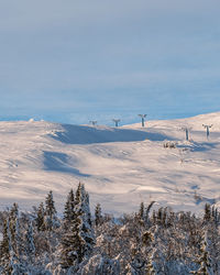 Scenic view of snow covered mountains against sky