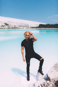 Full length of man standing on sea shore against sky