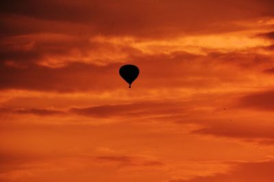 Low angle view of hot air balloon against orange sky