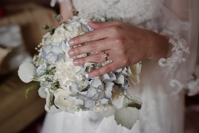 Close-up of hand holding flower bouquet