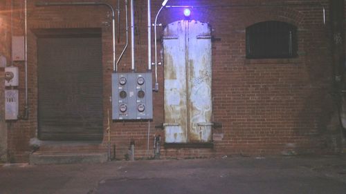 Low angle view of illuminated brick wall