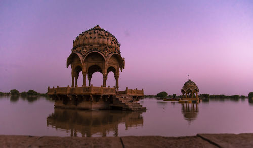 Gazebo in lake against sky