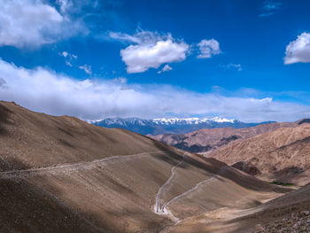 Scenic view of landscape and mountains against blue sky