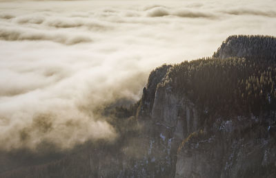 High angle view of cliff by clouds