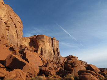 Low angle view of rock formation against blue sky