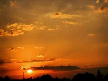 Scenic view of dramatic sky at sunset