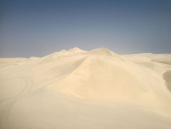 Scenic view of snowcapped mountains against clear sky