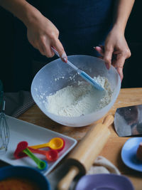 Close-up of woman preparing food at table