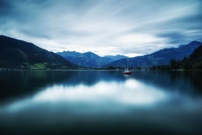 Scenic view of lake and mountains against sky