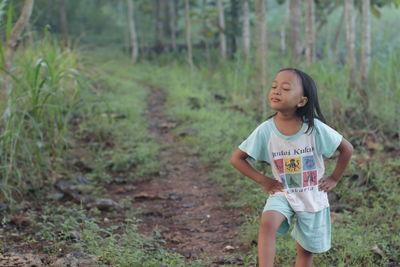 Full length of girl standing on field