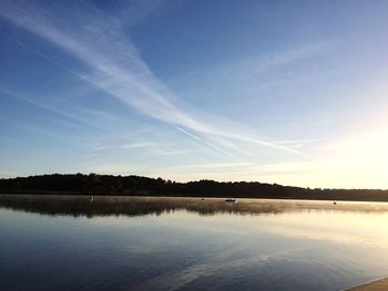 Scenic view of lake against clear blue sky