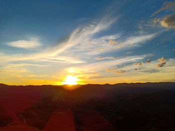 Scenic view of silhouette mountains against sky during sunset