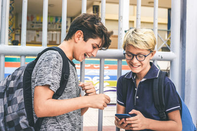 Portrait of smiling young man using smart phone