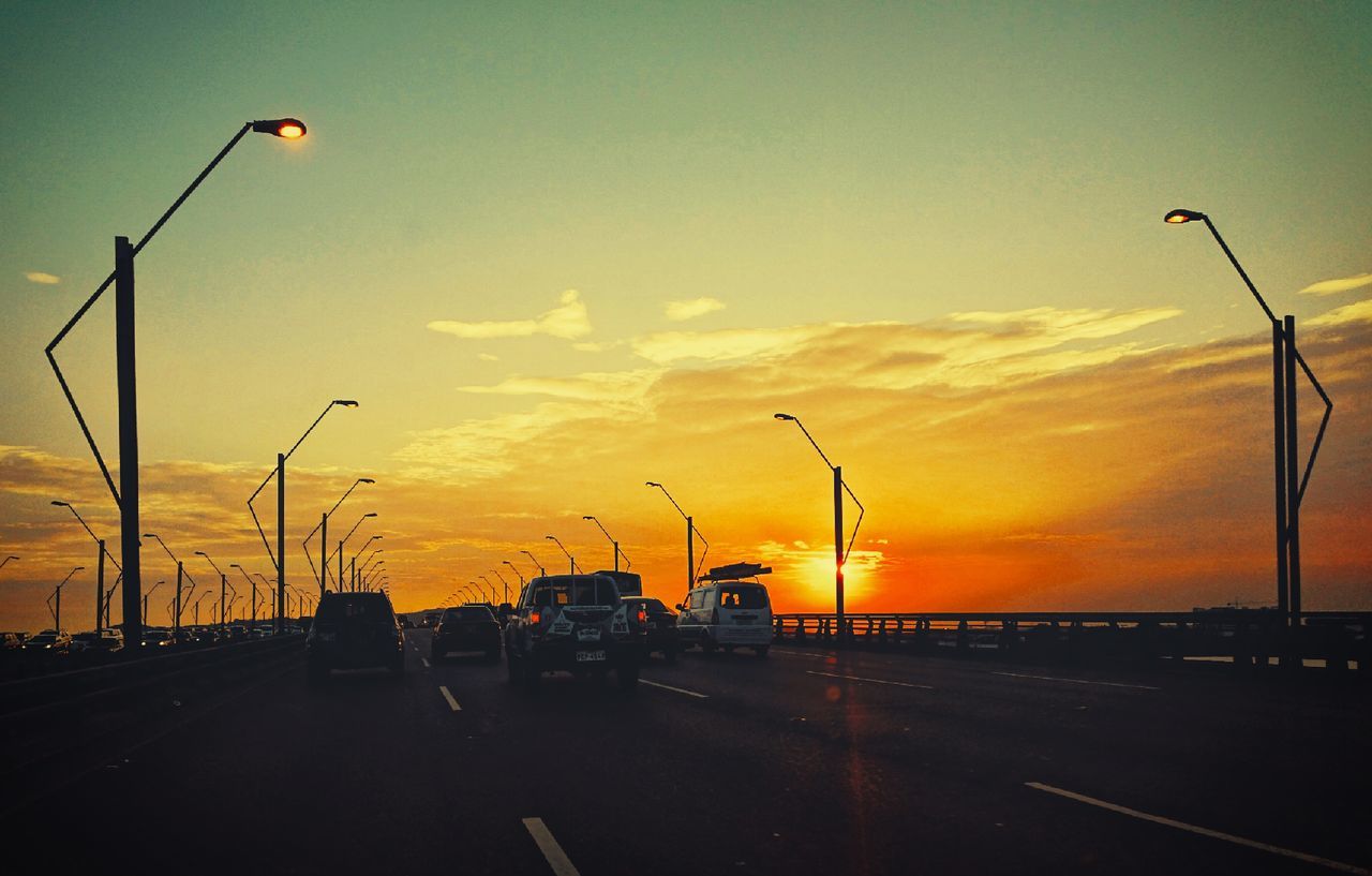 CARS ON ROAD AT SUNSET